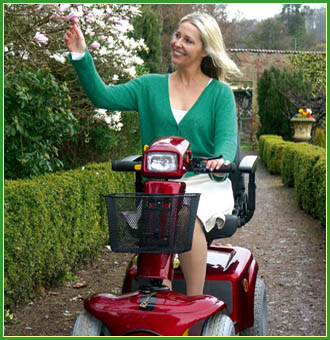 Lady on a scooter smiling an waving